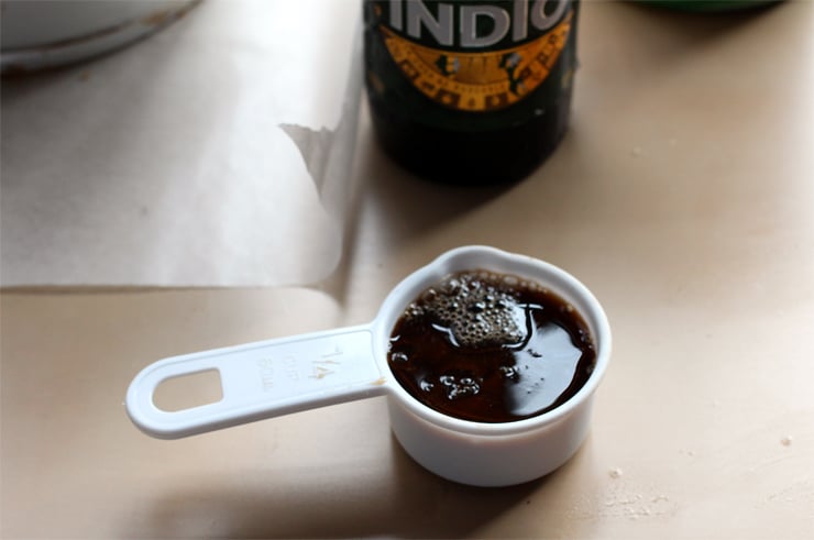 A quarter measuring cup filled with beer.