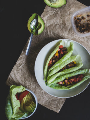 Cabbage wraps filled with chickpea taco meat on a white plate.