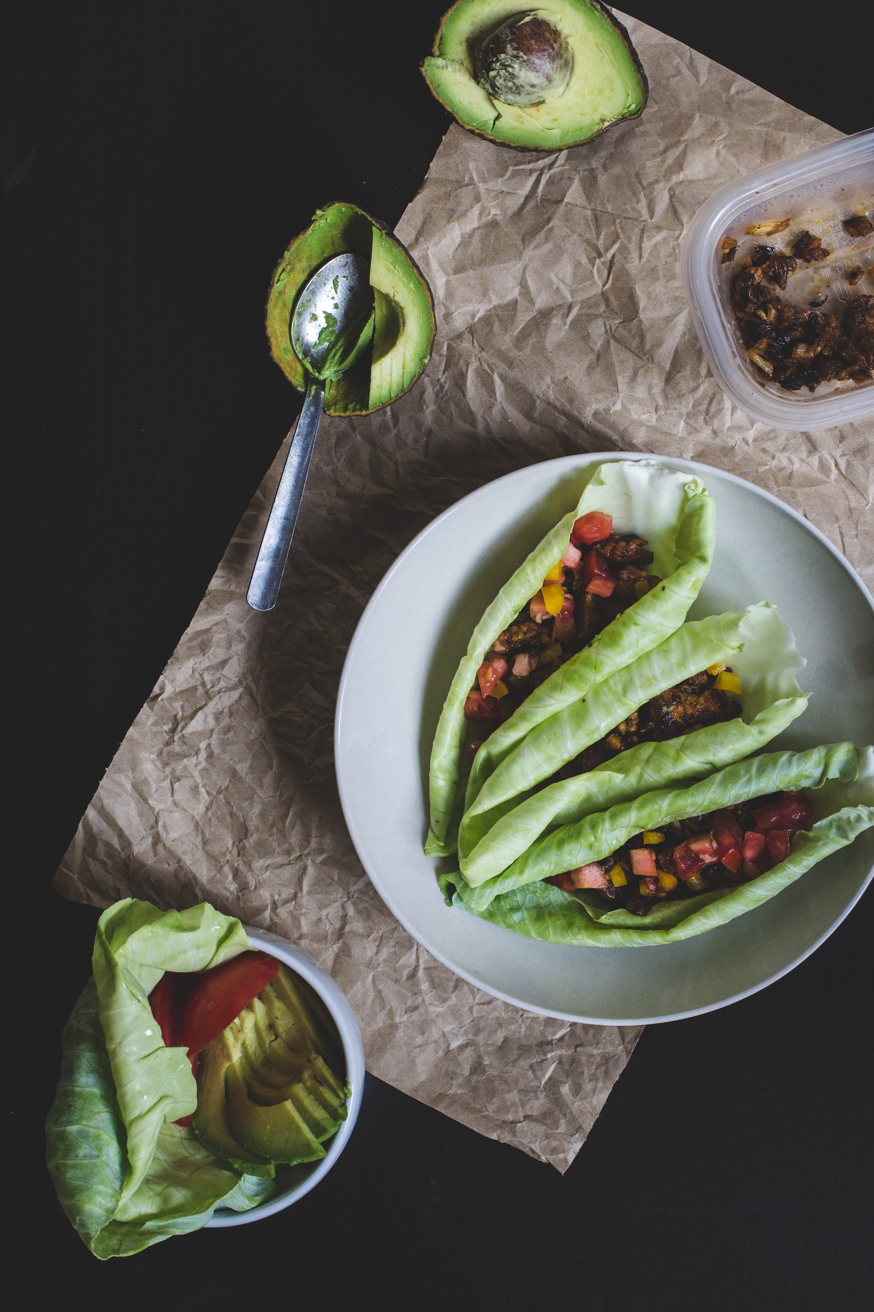 Cabbage wraps filled with chickpea taco meat on a white plate.