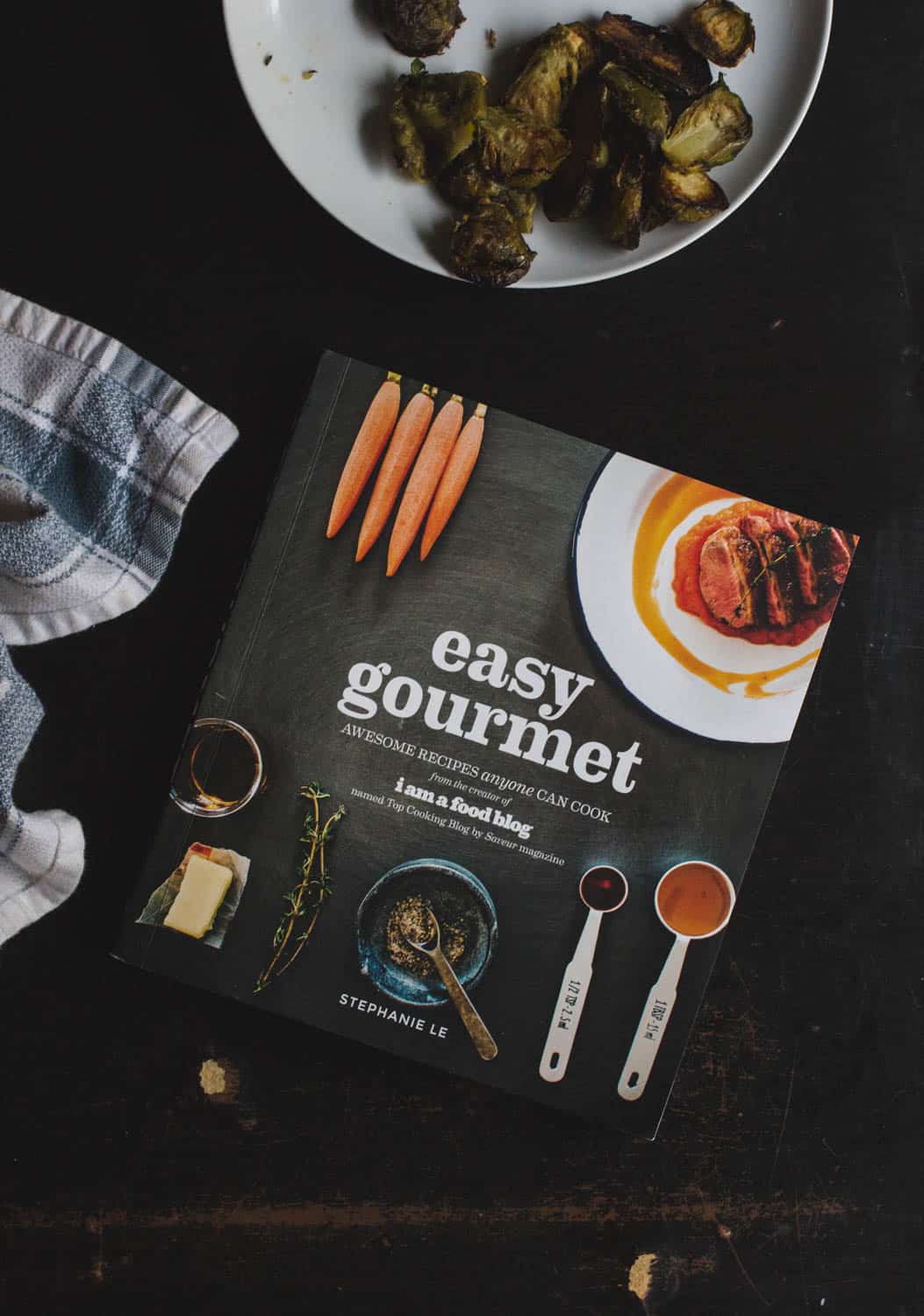 Easy Gourmet cookbook on a black table.