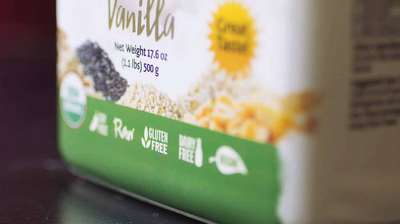 A close up on a container of Sunwarrior protein powder showing a \"gluten free\" label.