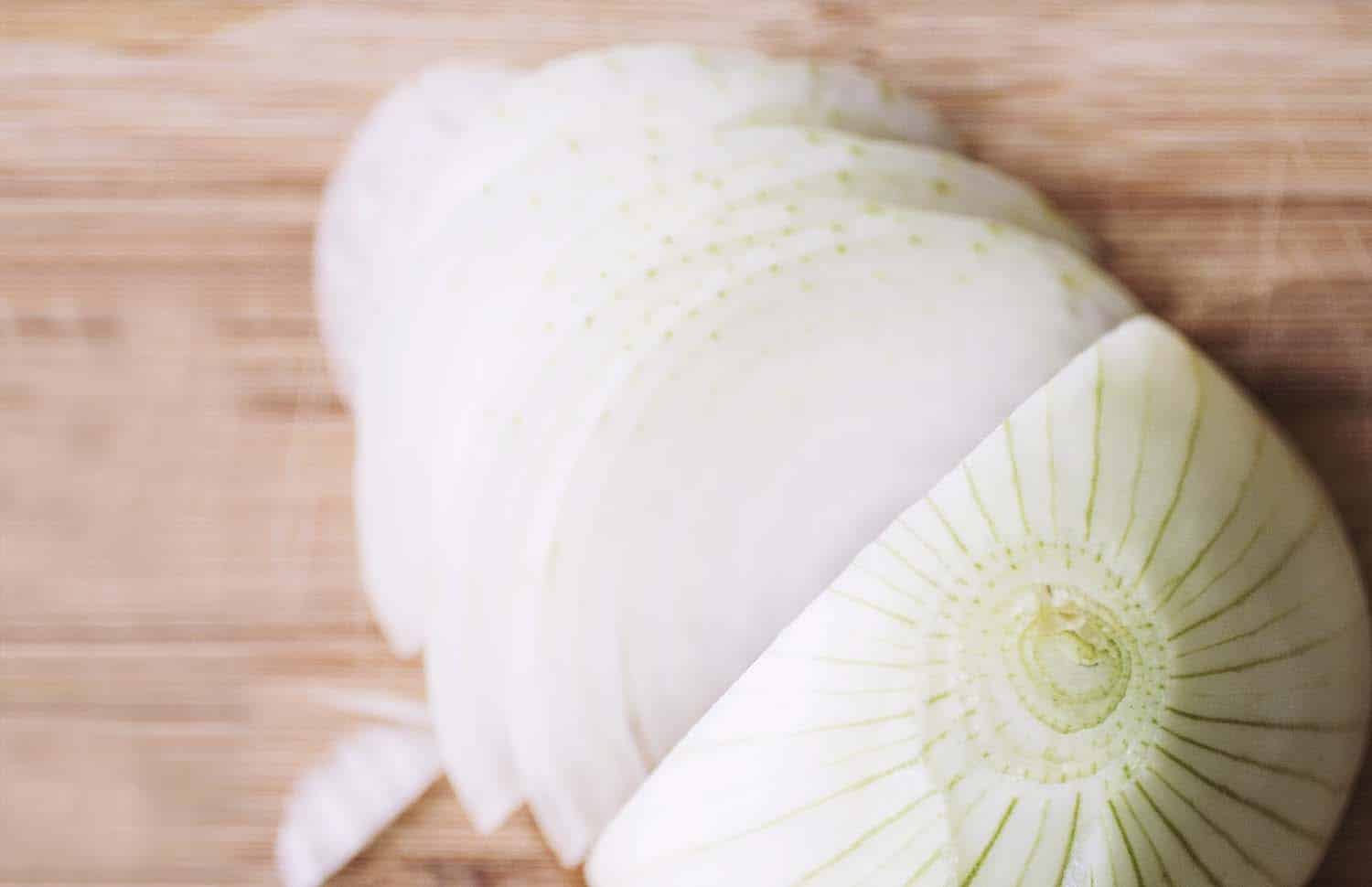 Close up on a half-sliced onion.