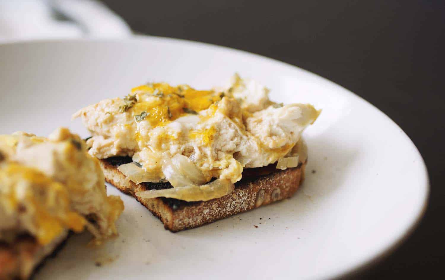A slice of bread topped with tofu oyakodon.