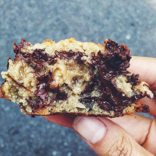 A hand holding a gooey Levain copycat cookie.