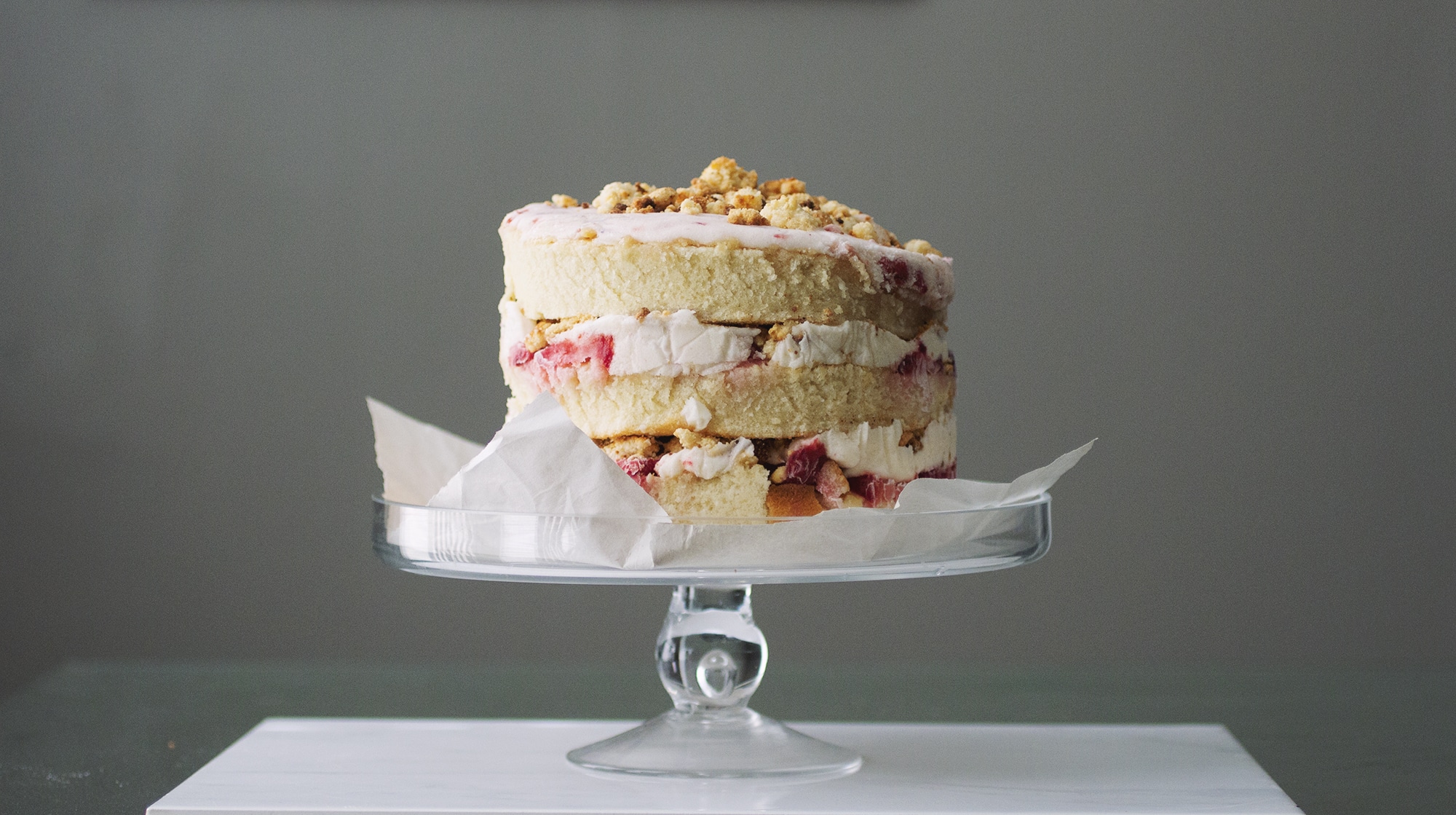 A triple strawberry cake with milk crumbs.
