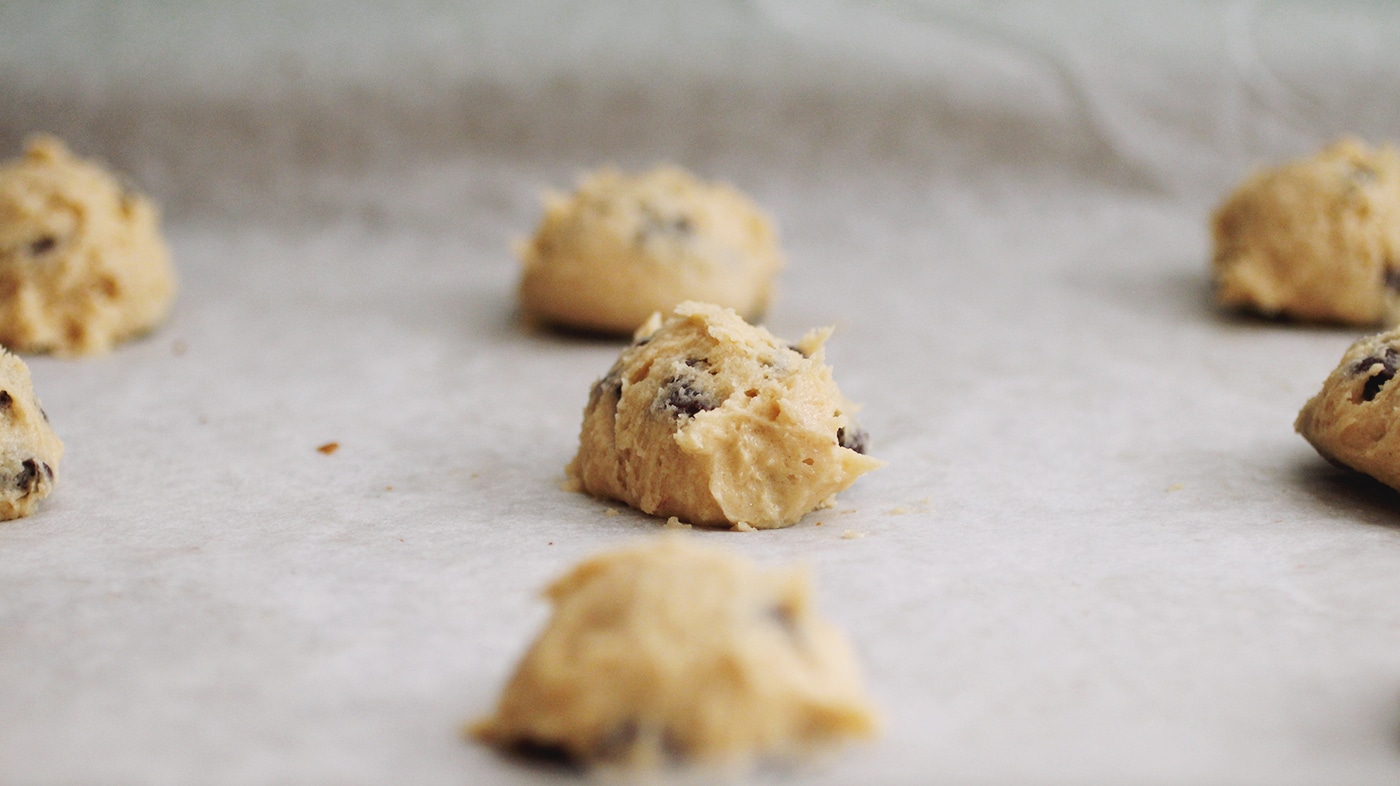 A close up on several balls of chocolate chip cookie dough.
