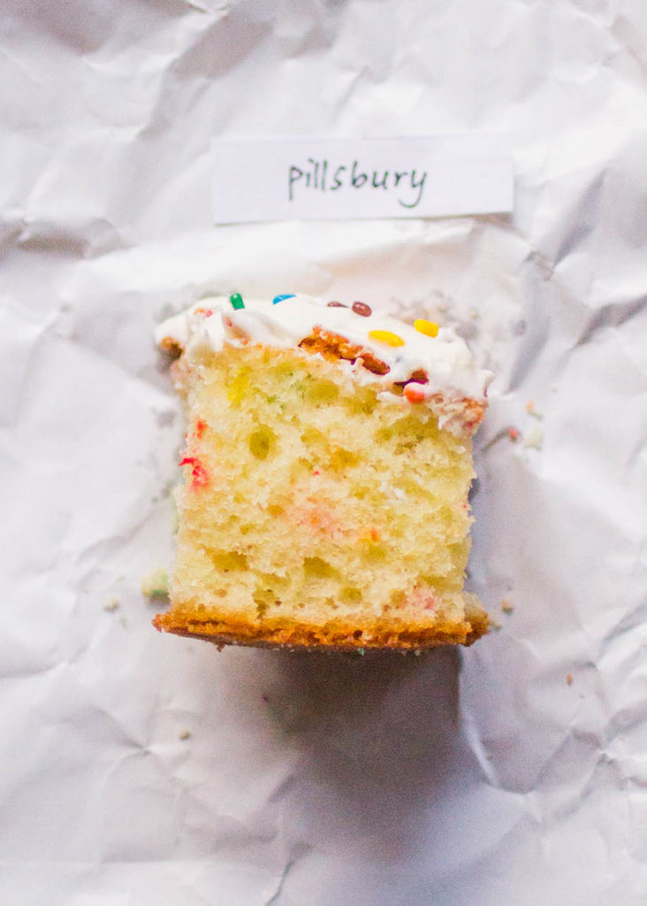 Single slice of Pillsbury sprinkle cake on white parchment paper.