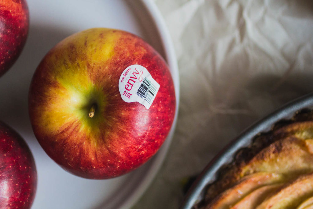 Close up on an apple with an Envy sticker.