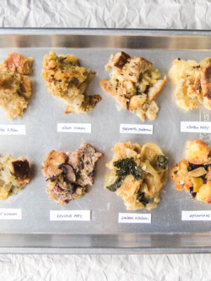 8 different vegetarian stuffings on a silver tray with labels.