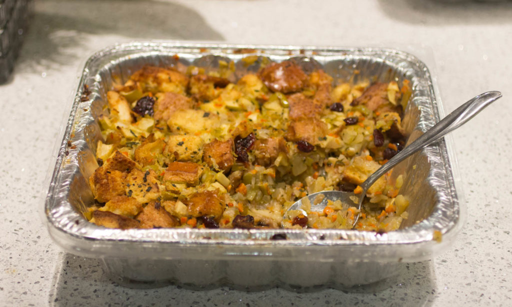A foil tray full of vegetarian stuffing.