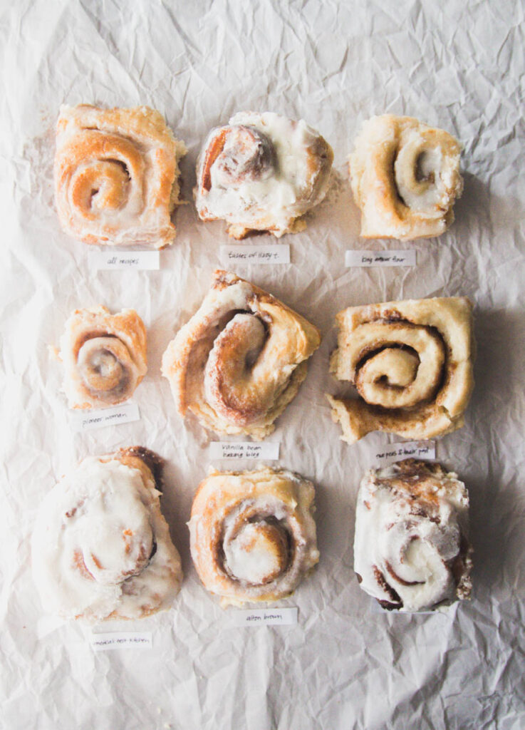 9 different cinnamon rolls on a gray background.