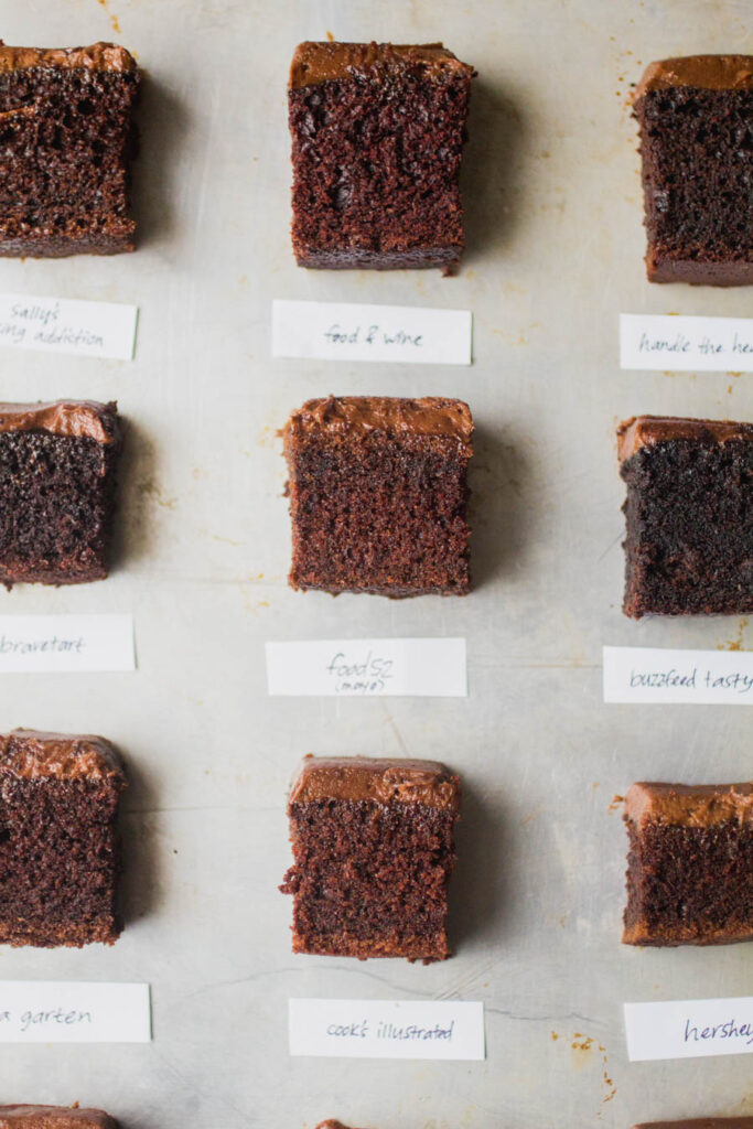 9 different squares of chocolate-frosted chocolate cake on a gray background.