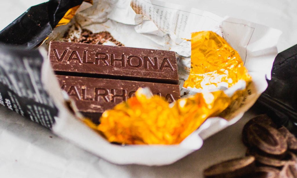 Close up of a Valrhona chocolate bar resting on foil.