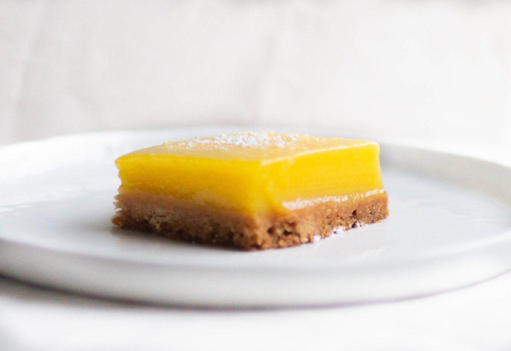 Single slice of Bravetart\'s sunny lemon bar.