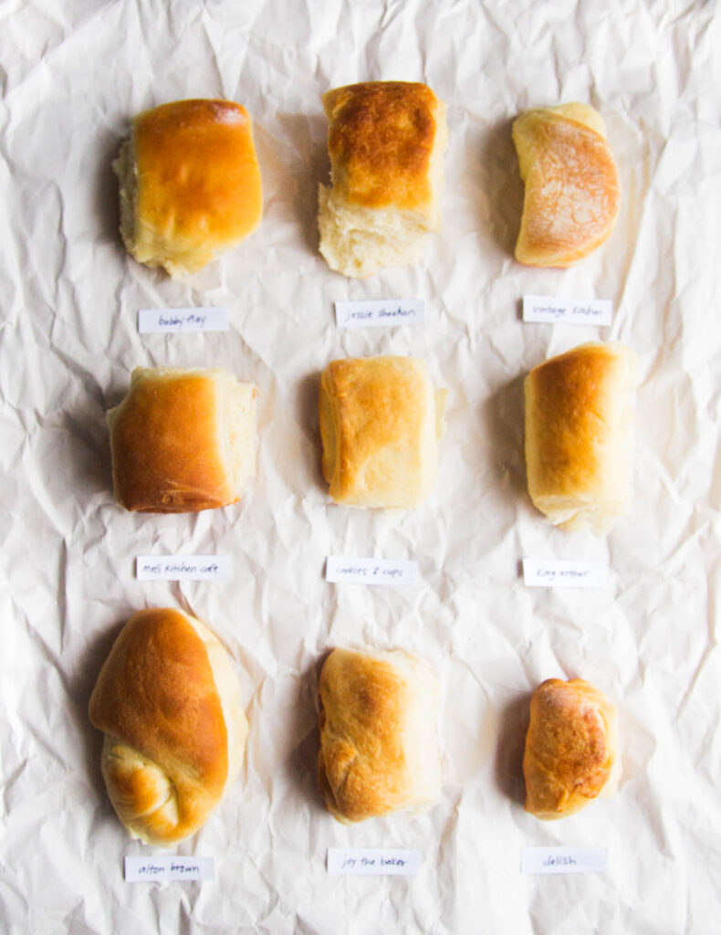 9 different Parker House rolls on a white background.
