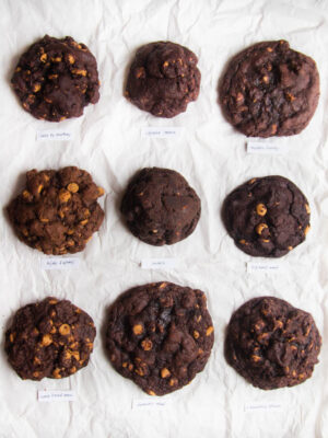 9 chocolate peanut butter chip cookies on a white background.