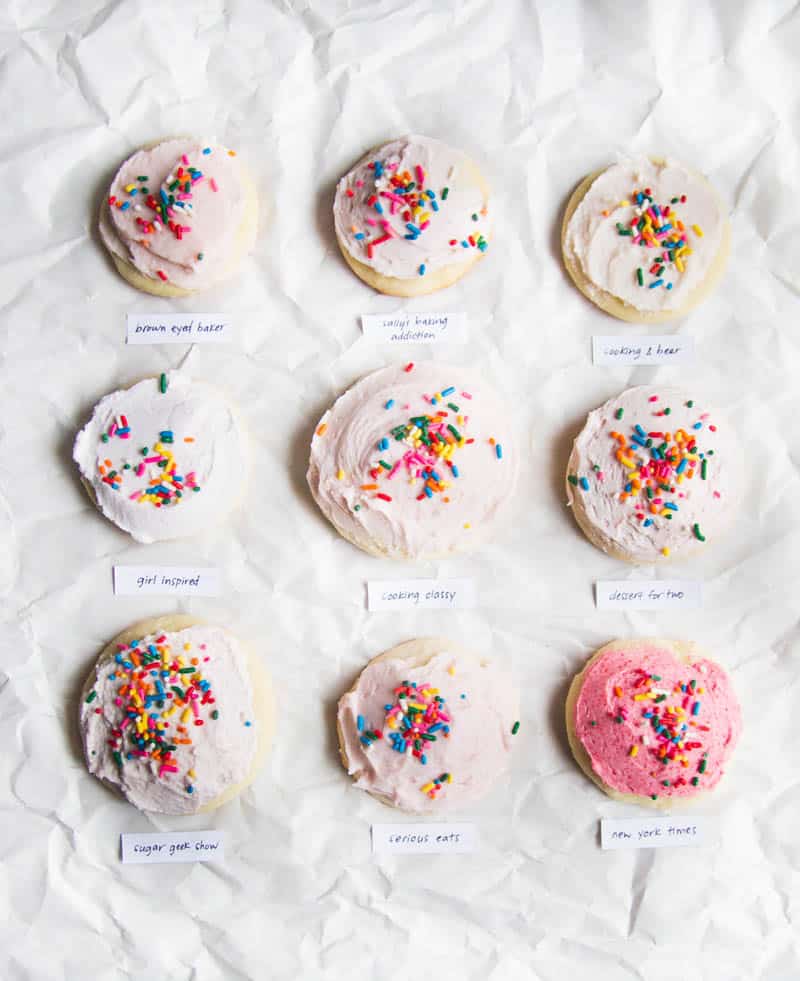 9 frosted sugar cookies with sprinkles on a white background.
