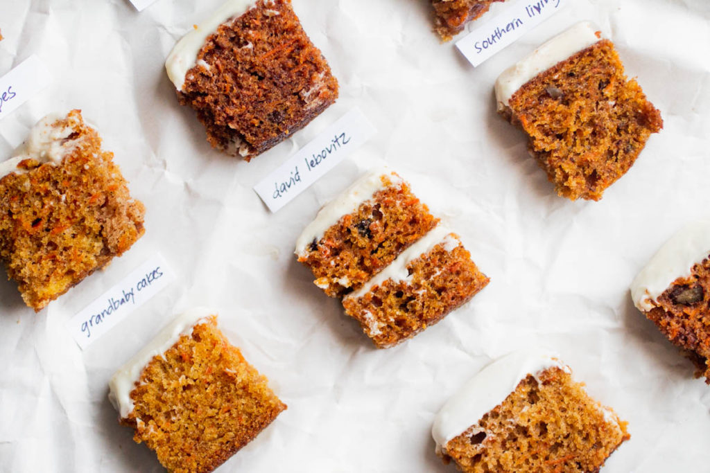 Small slices of different carrot cake recipes on parchment paper.