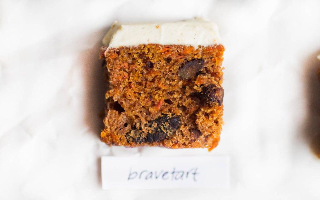single slice of bravetart carrot cake on parchment paper.