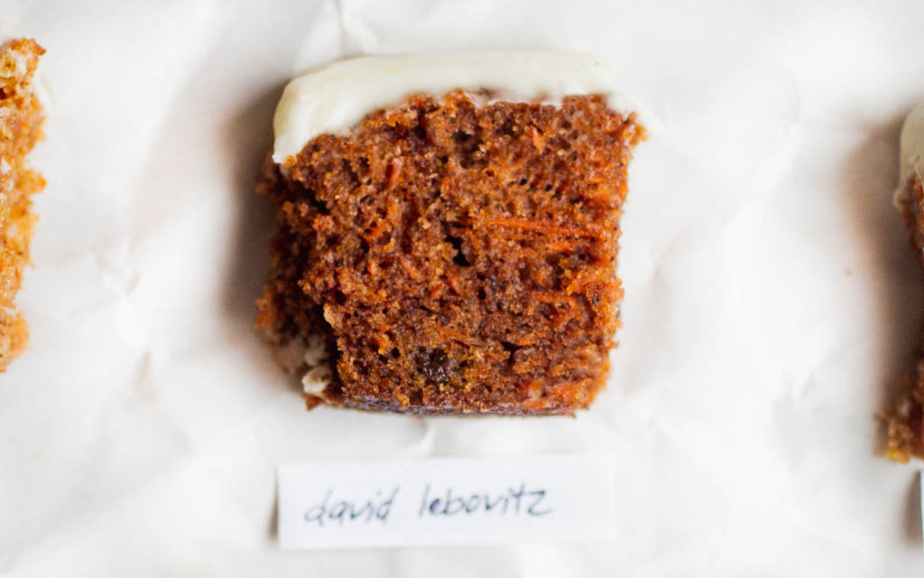 single slice of carrot cake on white parchment paper - recipe by david lebovitz.