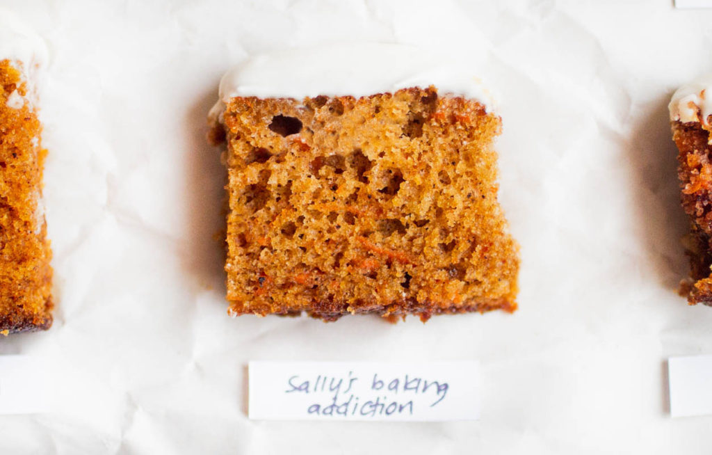 single slice of sally\'s baking addiction carrot cake on parchment paper.