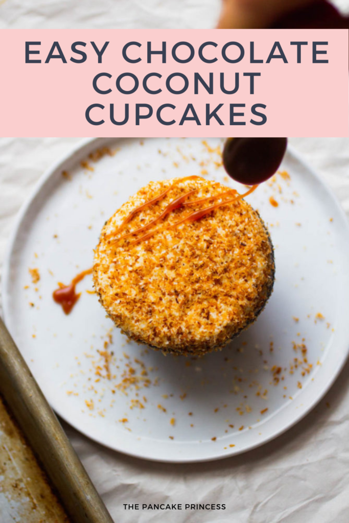 A spoon drizzling caramel on a coconut topped cupcake.