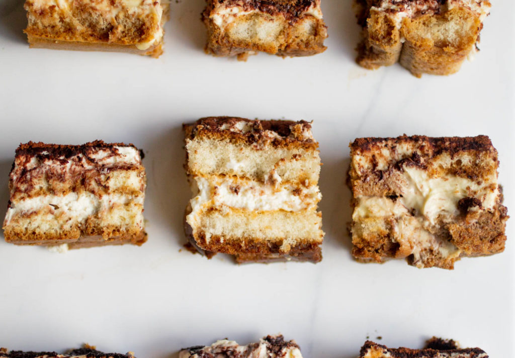 9 pieces of tiramisu on a white background.