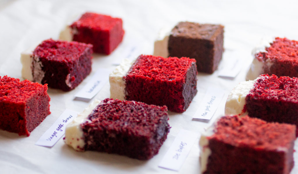 A close up of a few squares of red velvet cake.