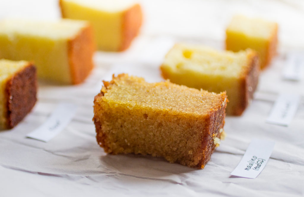 a close up on a cube of golden olive oil cake.