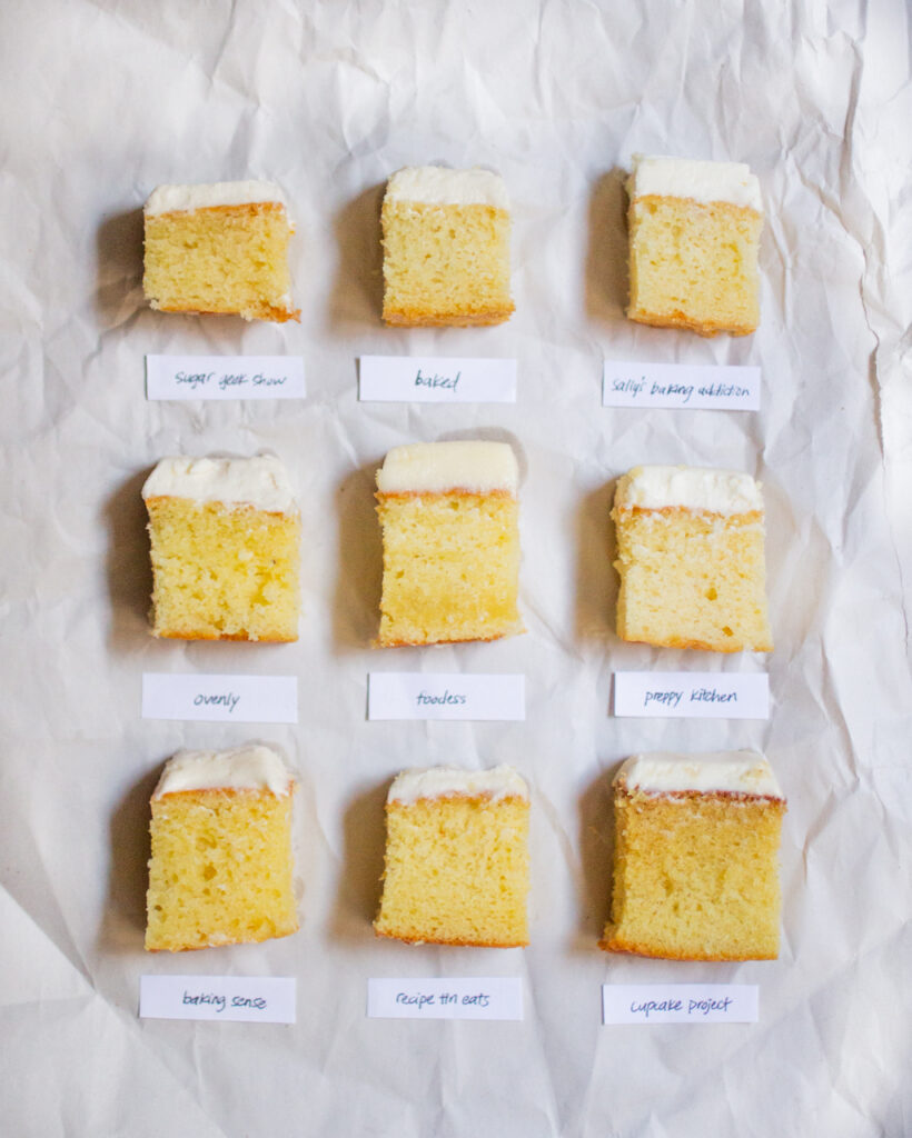 9 square pieces of frosted vanilla cake on a white piece of paper.