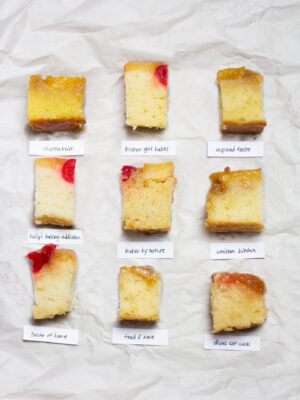 9 slices of pineapple upside down cake on crinkled off white paper.