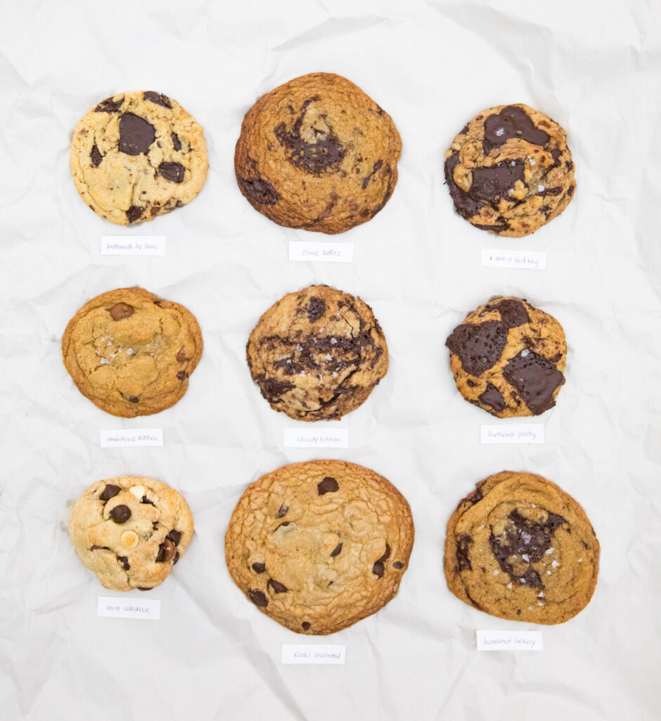 9 brown butter chocolate chip cookies on a white paper background.