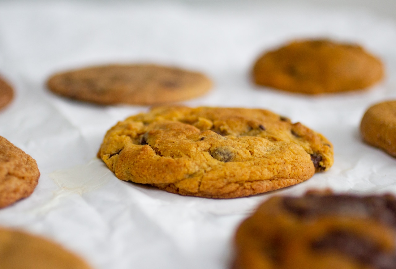 pumpkin cookie on top of white parchment paper.