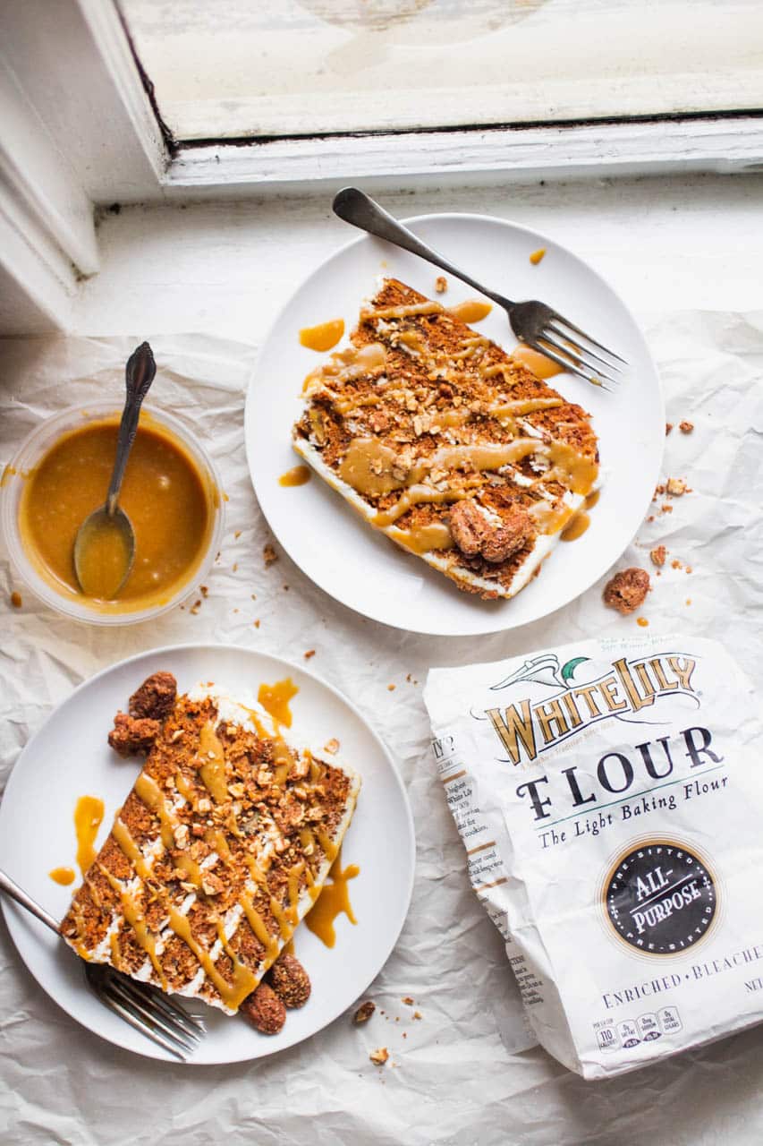Two slices of 4-layer coffee cake next to a bag of White Lily Flour.