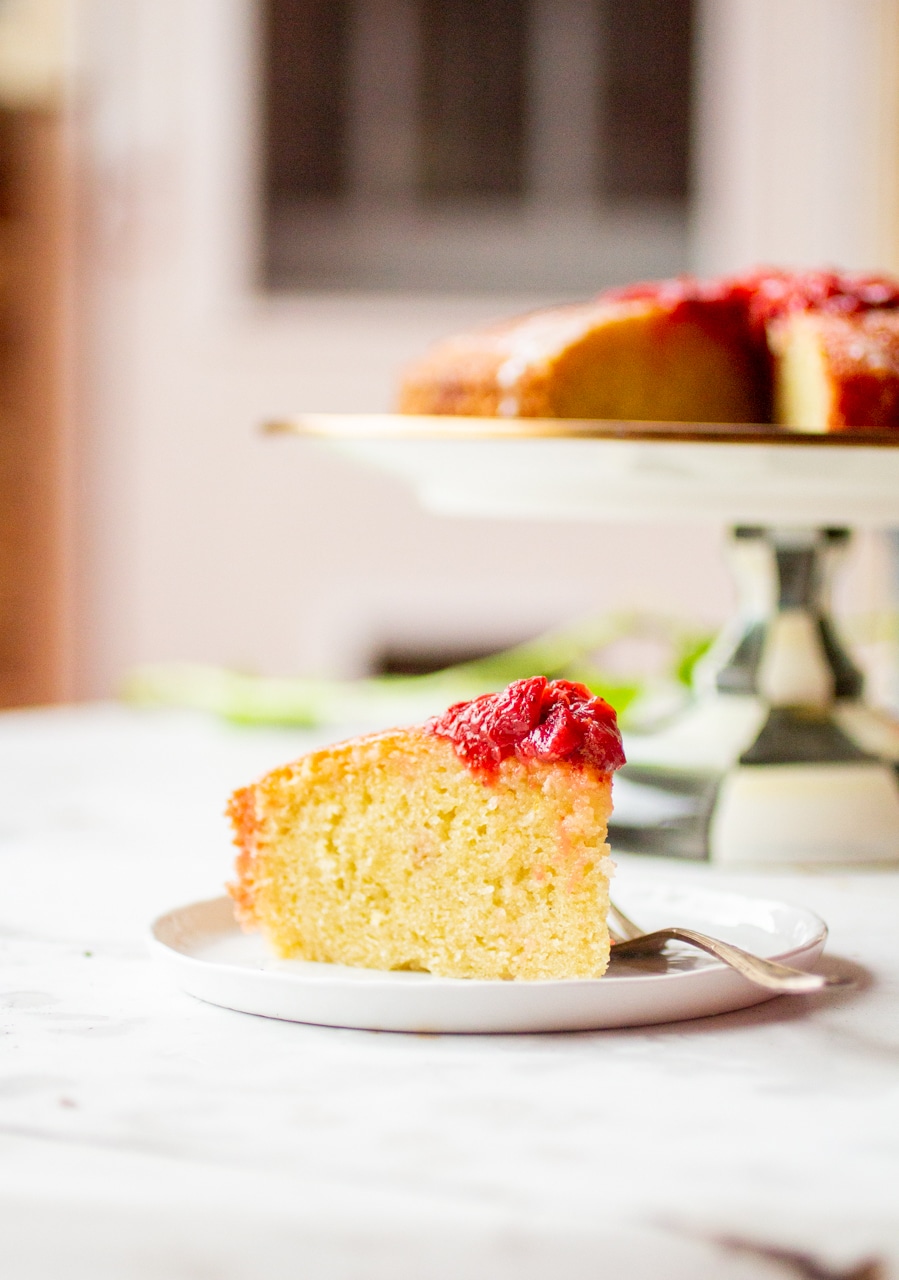 A slice of golden olive oil cake on a white plate.