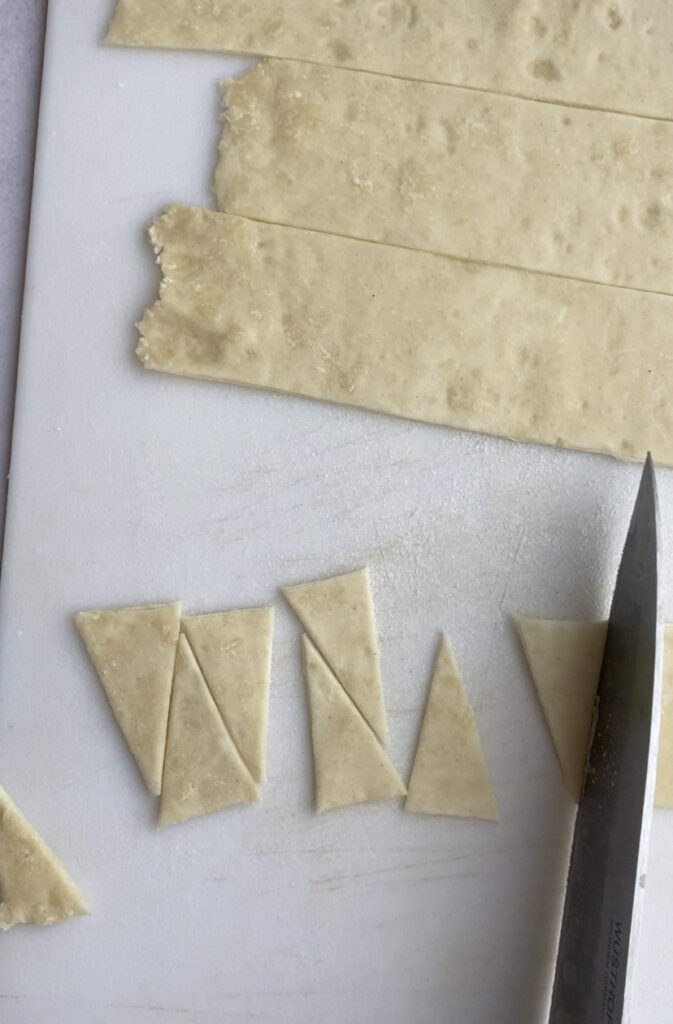 A sheet of puff pastry cut into little triangles.