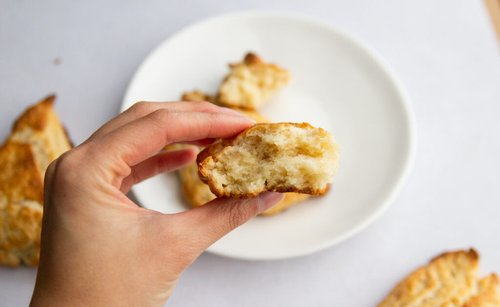 Holding up half of a scone to see the crumb.