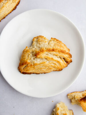 a golden scone on a white plate