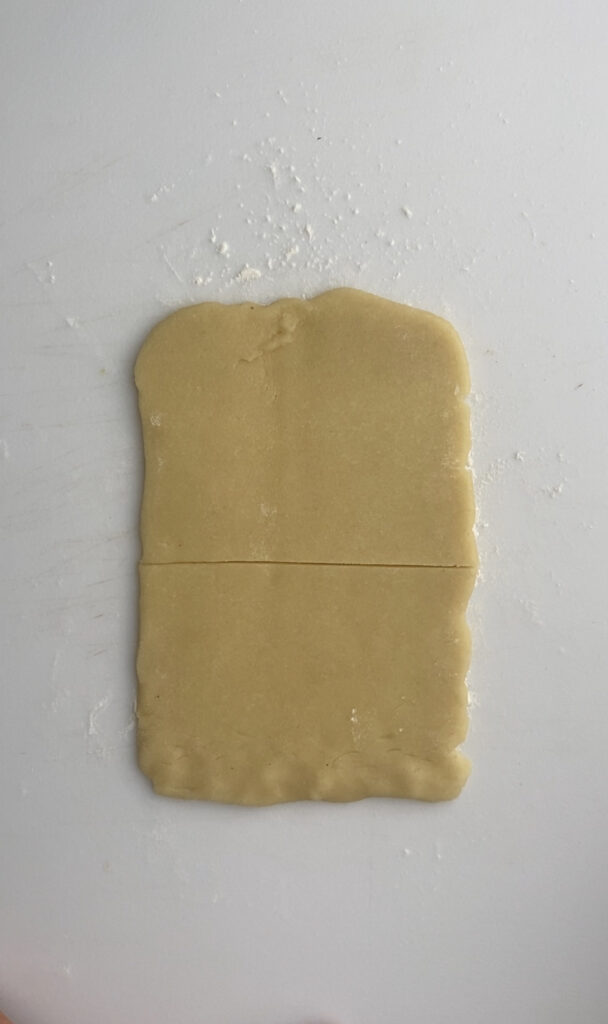 Almond paste rolled out into a rectangle and cut in half.