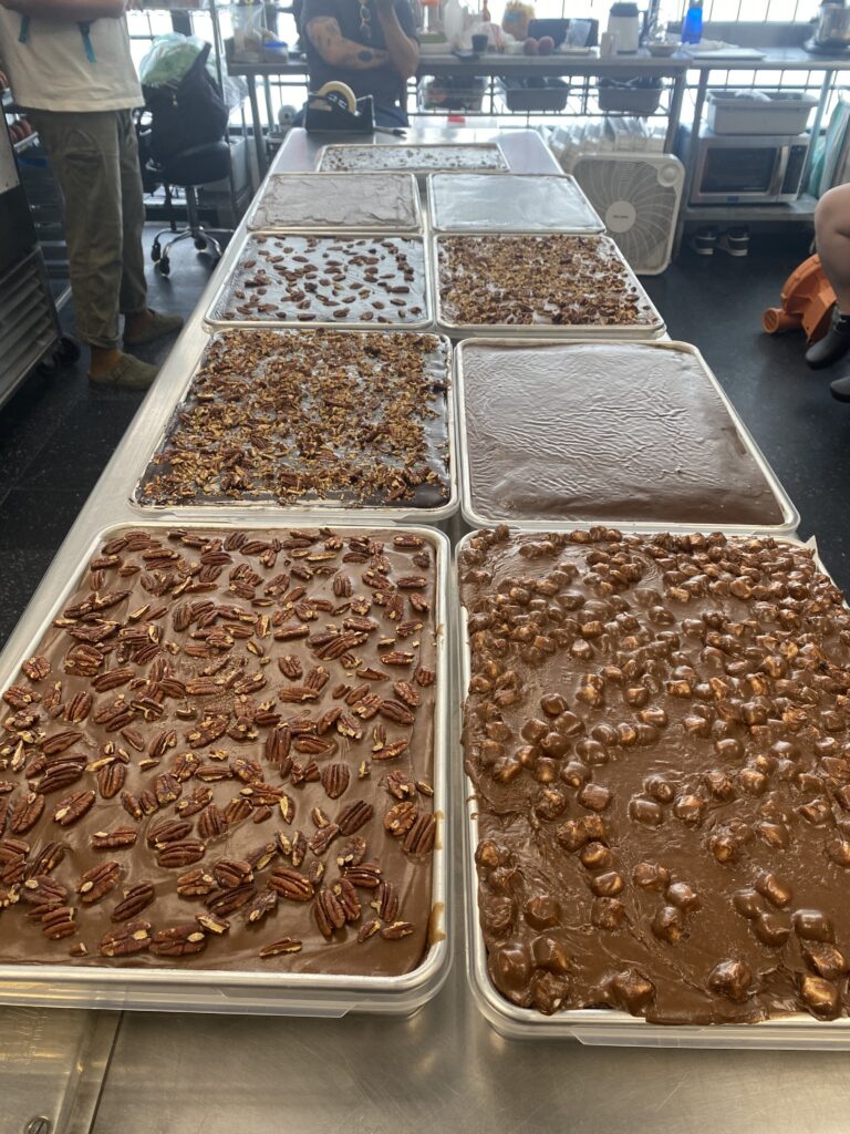 9 full Texas sheet cakes laid out on a table.