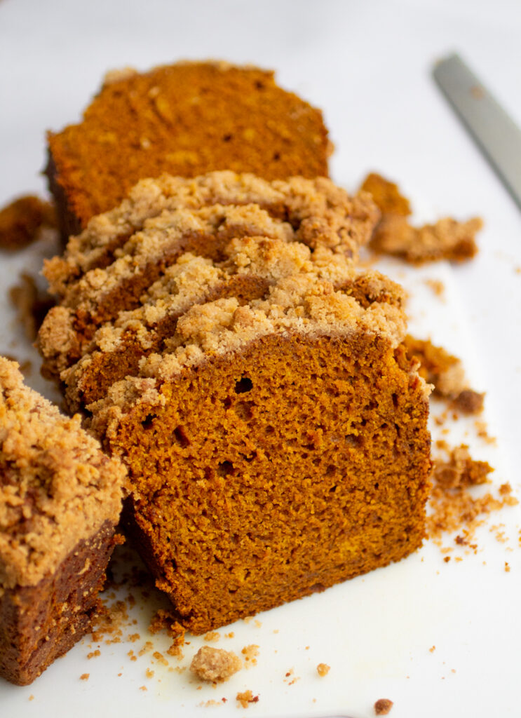 slices of pumpkin streusel bread on a cutting board.