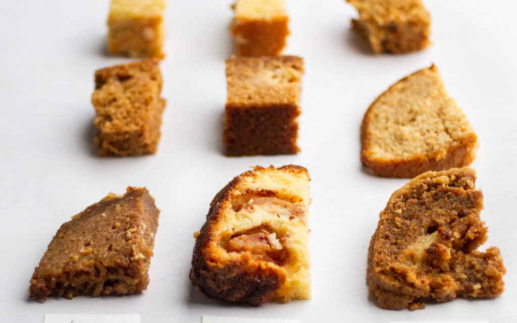 9 different pieces of apple cake on a white background.