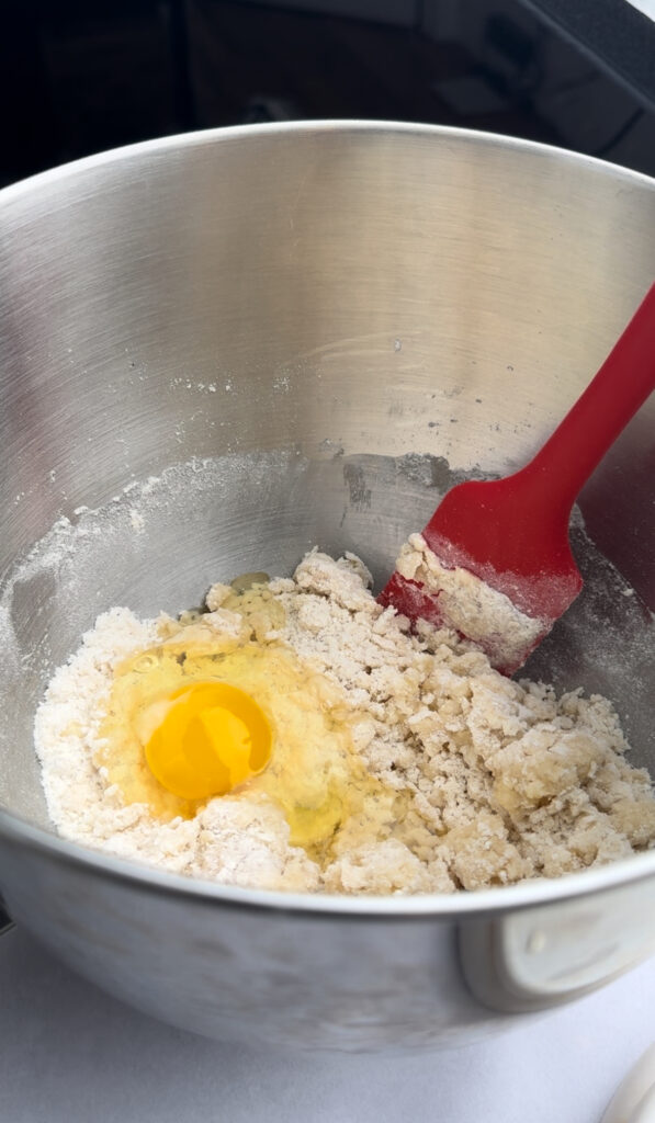An egg is added to the dry ingredients.