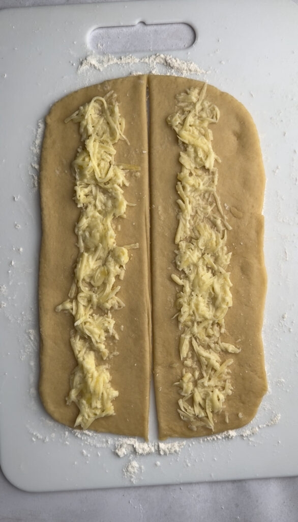 Dough is filled with cheese filling down the center.