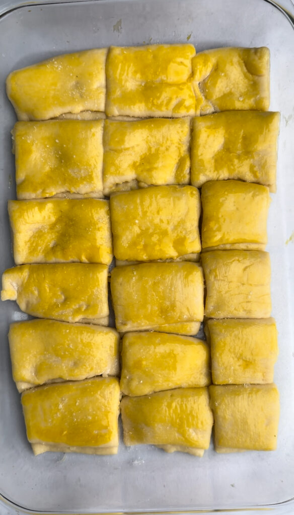 Unbaked rolls are brushed in egg wash.