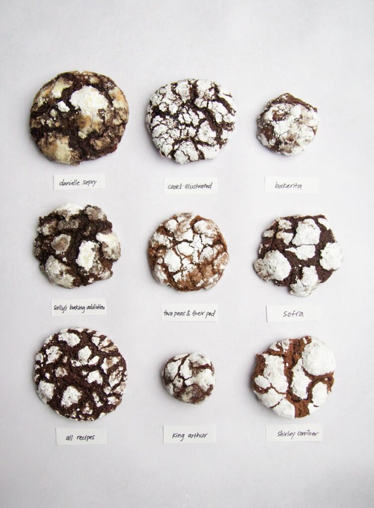 9 chocolate crinkle cookies on a gray background.