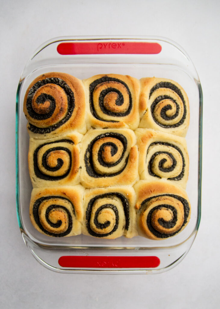 a square pan of baked black sesame sweet rolls.