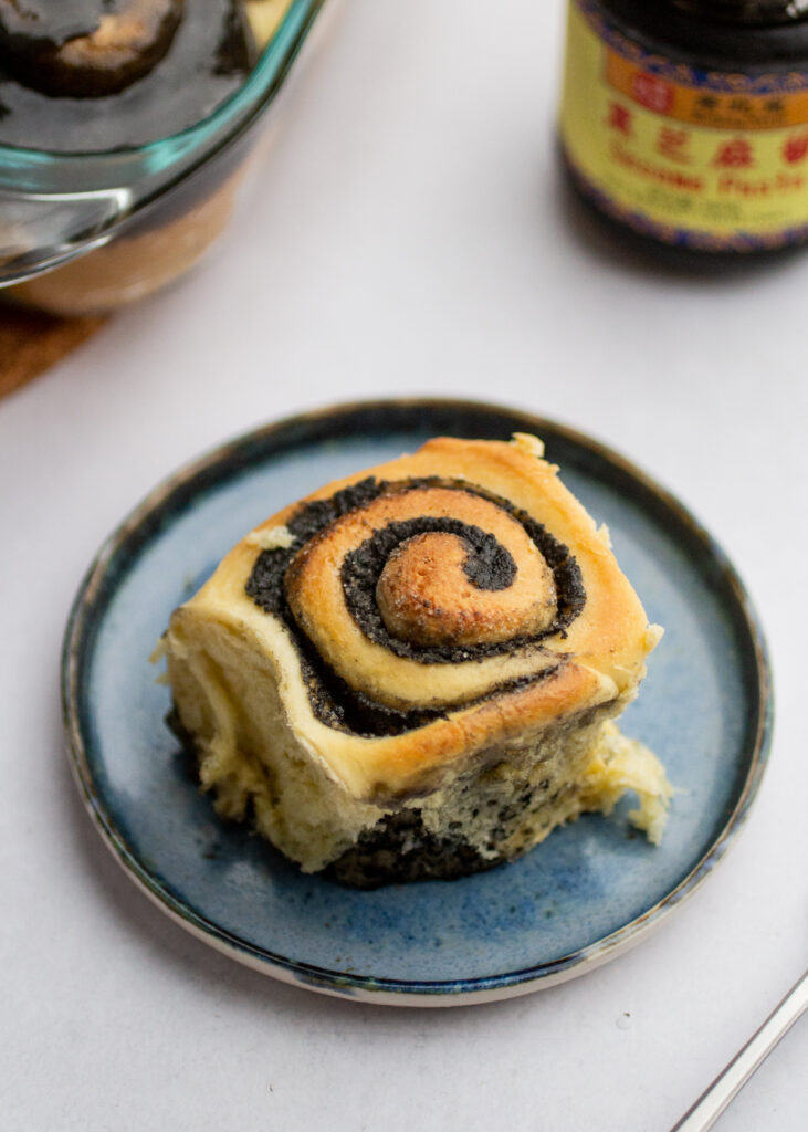 a black sesame roll on a blue plate.