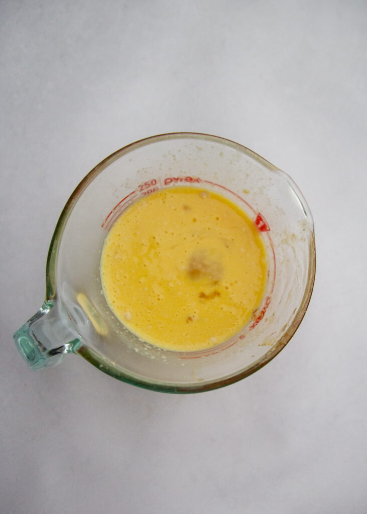 Egg and wet ingredients in a mixing bowl.