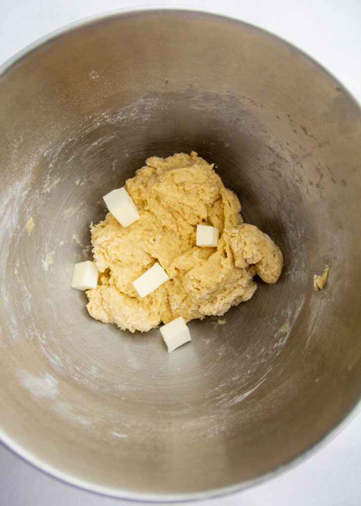Chunks of butter on top of yeasted dough.